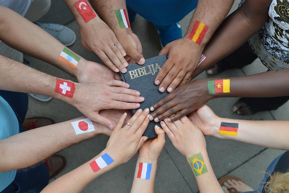 bible with hands and flags